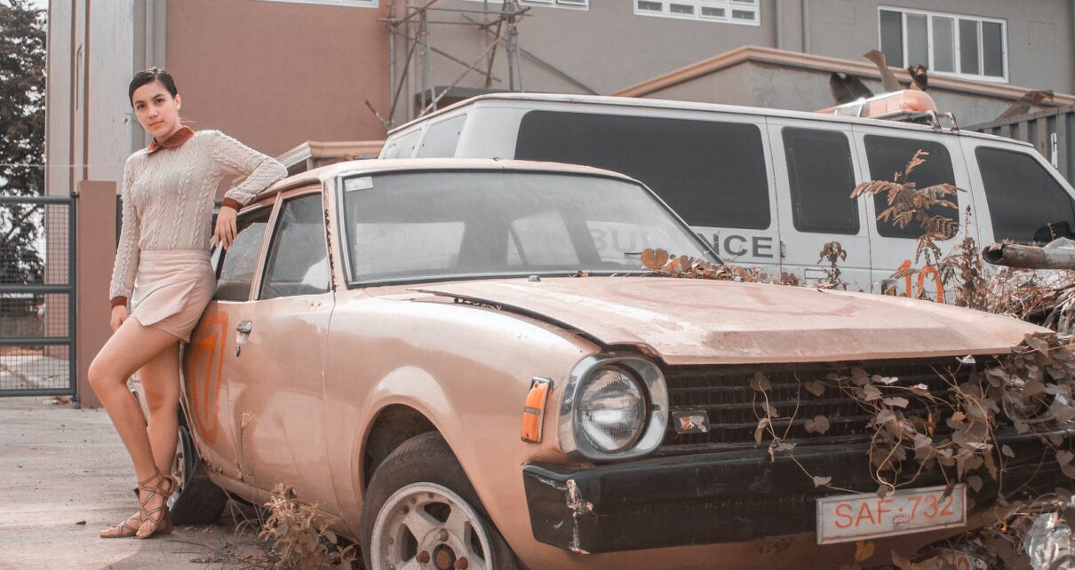 Woman Posing Beside An Abandoned Car